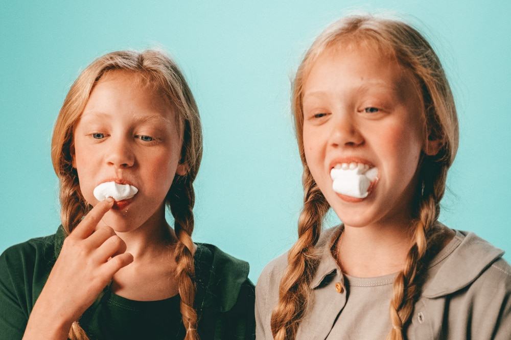 Two girls playing chubby bunny