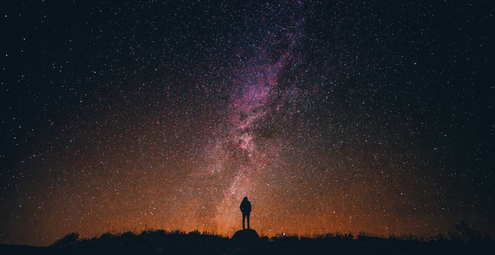 A person looking up at the stars