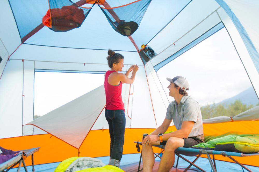 Two campers setting up the Eureka! Copper Canyon, one of our top picks for best cabin tent.