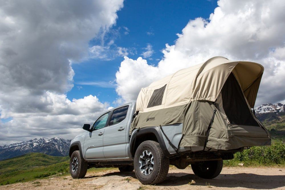 Kodiak canvas truck tent with rainfly on set up for camping on a truck vehicle