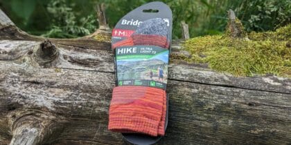 The Bridgedale Hike Ultra Light T2 Merino Performance socks sitting on a treestump outdoors
